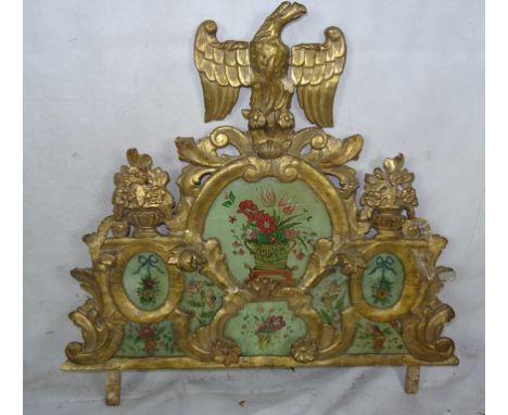 An 18th century carved wood gilded crest with floral decoration in the manner of Thomas Chippendale