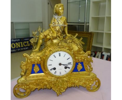 A 19th century gilt metal French mantel clock: enamel dial marked HRV Marc Paris surmounted by a shepherd
