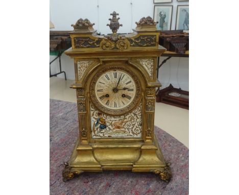 A 19th century mantel clock with Anglia architectural case, enamelled dial, with medieval page, hunting dog and archer amongs
