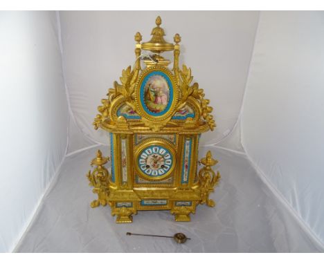 A 19th century French gilt mantel clock with halo-painted pastoral scene in Sevres style with Japy Freres movement CONDITION 