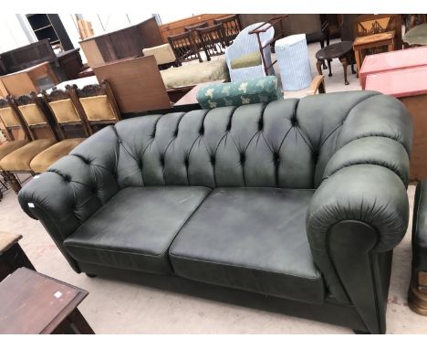 A GREEN LEATHER TWO SEATER BUTTON BACK CHESTERFIELD ARMCHAIR AND FOOTSTOOL 