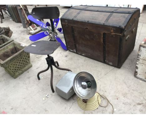 AN INDUSTRIAL OFFICE CHAIR, THE BARBER POLYKYMATIC HEAT GENERATOR, AND A PROJECTOR 