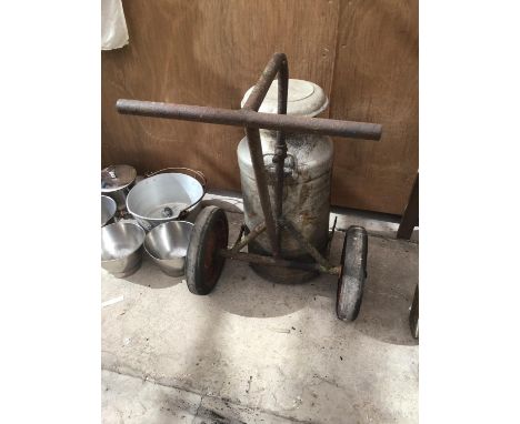A VINTAGE MILK CHURN AND TROLLEY 'GISBORNE DAIRY LTD CHAPEL EN LE FRITH' 