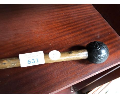 AN UNUSUAL METAL TOPPED WALKING STICK 