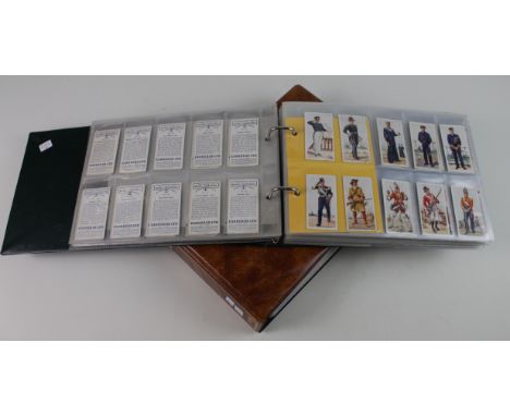 Collection of 31 complete sets contained in 2 modern albums, 1 military related &amp; the other flowers, sets from Will's Car