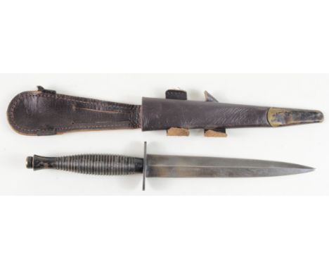 Commando dagger stamped 'Sheffield England' and with W/D arrow stamp, plus leather scabbard with metal tip