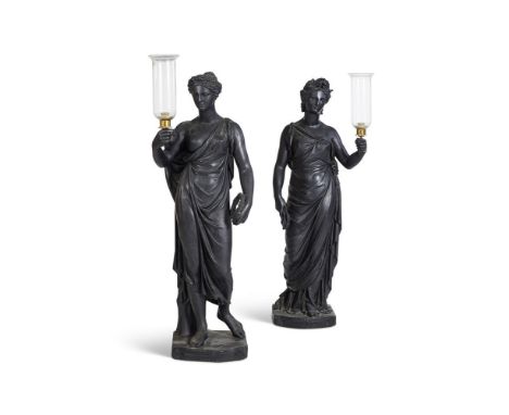 A PAIR OF EBONISED PLASTER FEMALE TORCHERE FIGURES BY HENRY HOPPER  EARLY 19TH CENTURY AND LATER  With later storm candle hol