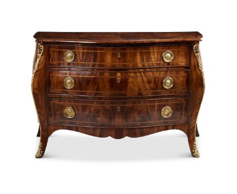 A GEORGE III FIGURED MAHOGANY, CROSSBANDED AND ORMOLU MOUNTED BOMBE COMMODE CIRCA 1780 The shaped top with Goncalo Alves band