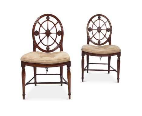 A PAIR OF GEORGE III MAHOGANY HALL CHAIRS  ATTRIBUTED TO INCE & MAYHEW, CIRCA 1790  Each with a 'spider web' back above the d