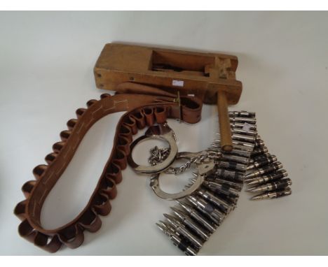 Vintage Klaxon, Pr. Of Handcuffs, Faux string of Bullets and a Leather cartridge belt      