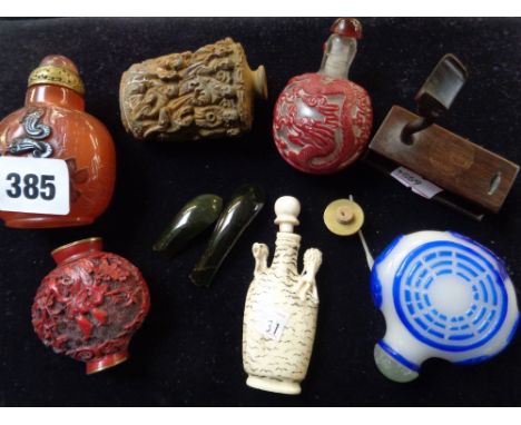 Collection of assorted Chinese Snuff bottles and a Green Spinach Green Jade piece on wooden stand    