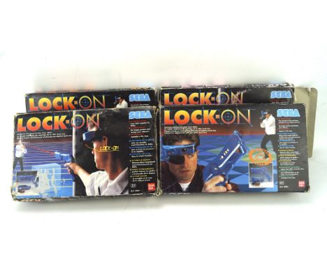 A group of four vintage Sega Lock On guns, each in original box