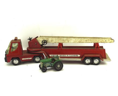 A vintage red Nylint aerial hook-n-ladder metal toy fire engine, 77cm long, together with a toy tractor