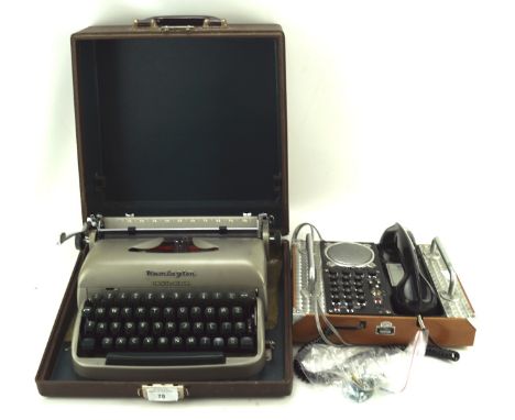 A vintage typewriter and Spirit of St Louis telephone, the typewriter a Remington Travel-Riter in a carry case, the telephone