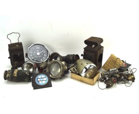 A selection of vintage bicycle lamps and car gauges, including a Smiths speedometer and a Miller lamp