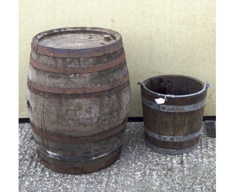 A vintage coopered wooden barrel and a similar bucket, both with metal castings, barrel 60cm high