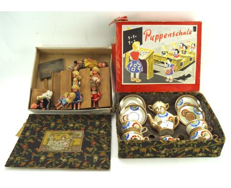 A vintage ceramic childs tea set and a selection of dolls, both in boxes