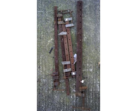 A group of large metal sash clamps, the largest measuring 140cm long