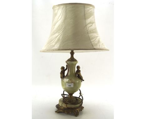 A gilt metal and stone table lamp, with two Cherubs adorning the central section, measuring 41cm high excluding shade