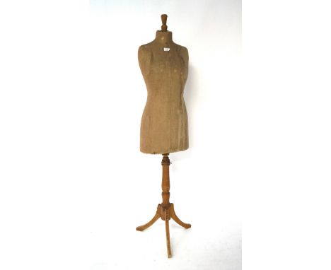 An early 20th century clothes mannequin, raised upon tripod base with cabriolet supports, size 40