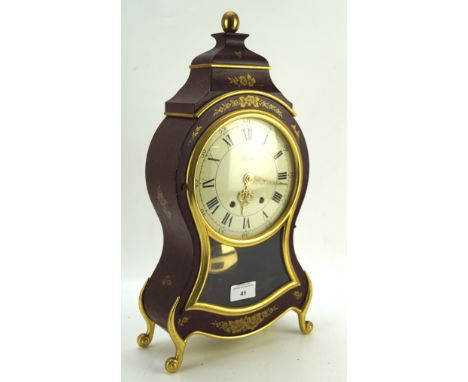 A 20th Century bracket clock by Eluxa, the dial with Roman numerals denoting hours, Swiss made, with bracket, 42cm high
