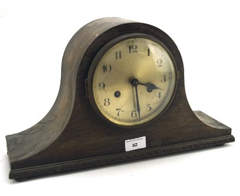 A Napoleon hat shaped mantel clock, the silvered dial with Arabic numerals, contsined within a mahogany case with carved deta