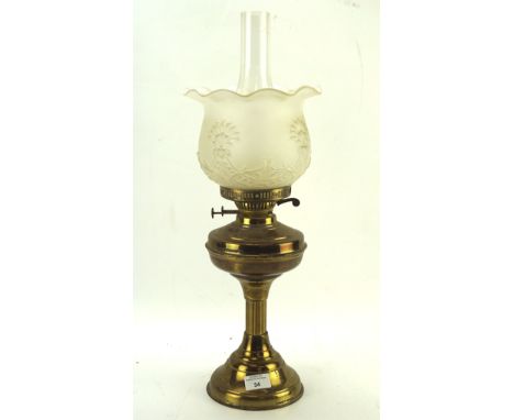 An early 20th century brass oil lamp, with moulded glass shade and clear glass funnel, approximately 56cm high