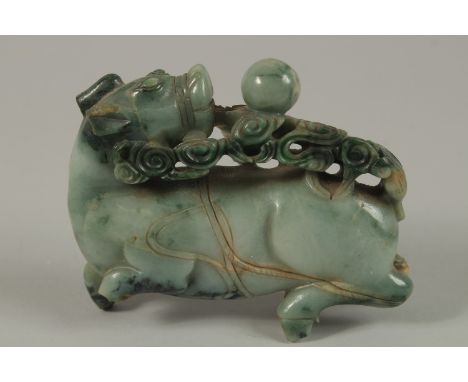 A CHINESE CARVED JADE FIGURE OF A BULL, 13cm long.