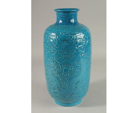 A CHINESE TURQUOISE GLAZE PORCELAIN LANTERN VASE, carved with dragons and stylised clouds, 35cm high.