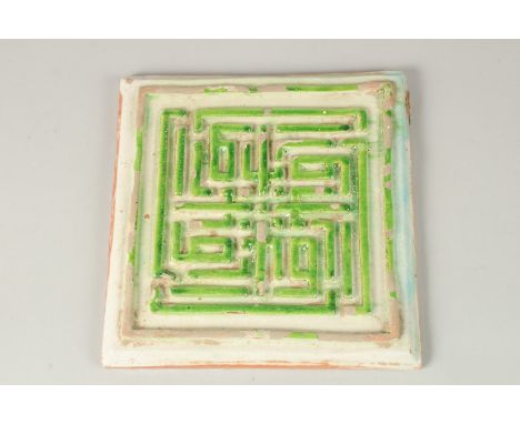 A VERY FINE AND UNUSUAL PERSIAN SAFAVID WHITE AND GREEN GLAZED POTTERY TILE, with raised Kufic calligraphy, 21cm x 21.5cm.