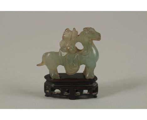 A CHINESE CARVED JADE MINIATURE FIGURE OF A MUSICIAN ON HORSEBACK, with wooden stand, jade 5cm long.