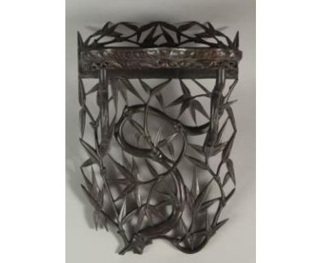 A CHINESE CARVED OPENWORK HARDWOOD WALL SHELF, carved with bamboo tree design, 46cm high.