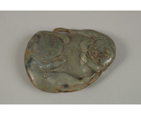 A LARGE CHINESE CARVED JADE PEBBLE, with two mythical beasts, 15cm x 11cm.