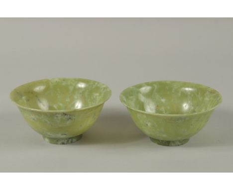 A PAIR OF CHINESE JADE BOWLS, 13cm diameter.