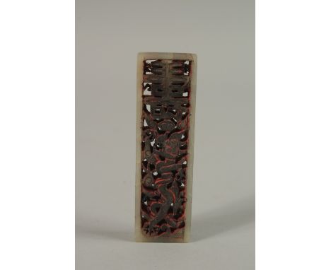 A SMALL CHINESE CARVED AND PIERCED JADE SEAL, 7cm long.