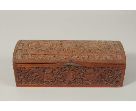 A VERY FINE THAI OR INDIAN CARVED WOOD RECTANGULAR BOX, with mythical creatures and fine foliate carving, 25.5cm long.