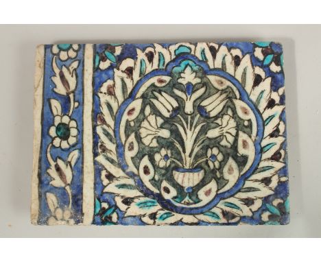 A FINE LARGE 17TH CENTURY OTTOMAN DAMASCUS GLAZED POTTERY TILE, with central floral panel, 27.5cm x 20cm.
