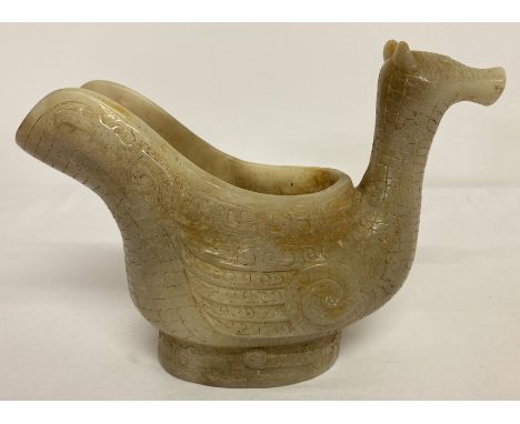 A carved white jade jug in the form of a mythical creature.  Approx. 18cm tall x 25cm wide.