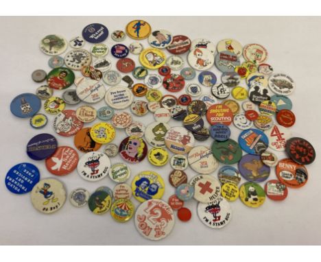 A tin containing a vintage badge collection.  