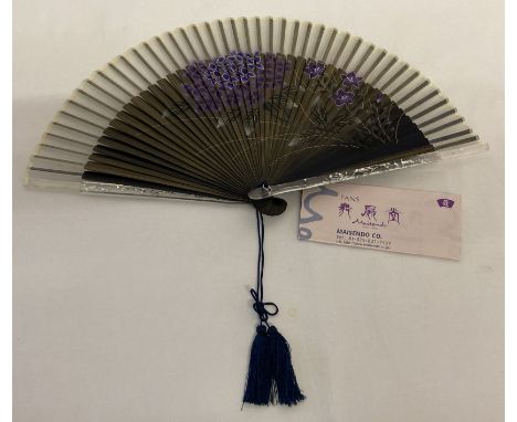 A modern Maisendo Kyoto Japanese fan with purple painted design. Together with accompanying leaflet. 