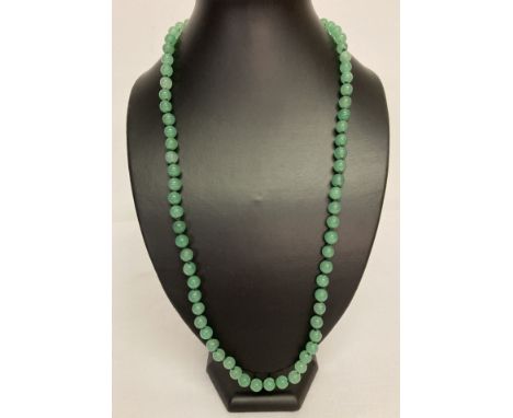 A 26" Chinese jade beaded necklace, knotted between each bead.  Bead size approx. 0.75cm diameter.