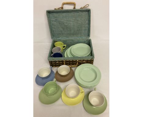 A small picnic basket containing a quantity of Gaydon Melmex ware plates, bowls, cups &amp; saucers.  