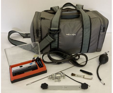 A vintage grey padded camera and gadget bag together with a boxed Kodak Instamatic camera. Lot also include a collection of c
