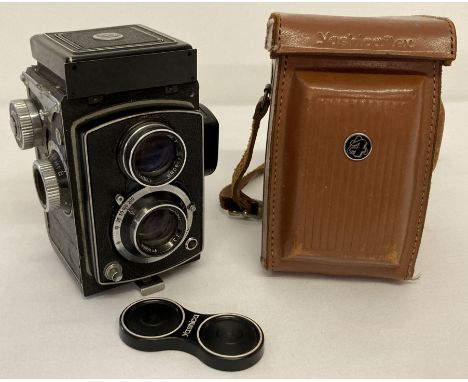 A 1950's Japanese Yashica Flex S Copal twin lens camera with original tan leather carry case. Complete with double lens cap. 