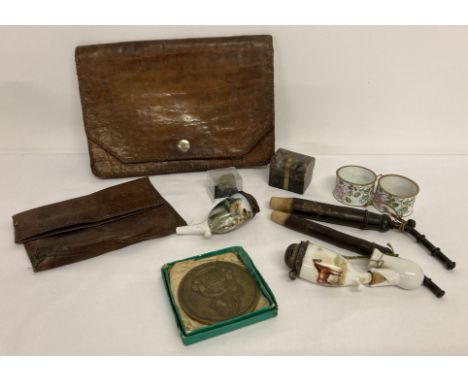 A small collection of vintage items to include ceramic pipes and pipe bowls, leather clutch bag and enamel napkin rings. 