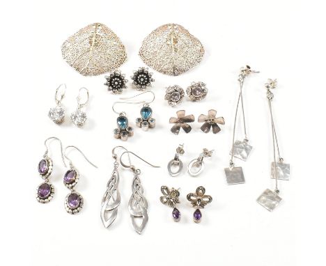 Assorted silver and gem set earrings. The twelve earrings to include, but not limited to studs, drop earrings, pendant earrin