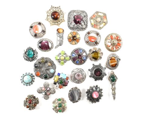A collection of metal gem set Celtic brooches. The lot to include twenty five Celtic style brooch pins including a dragon and