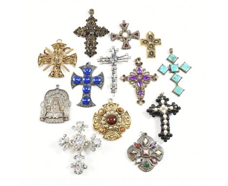 A collection of thirteen metal 20th century necklace pendants. The costume jewellery lot to include pendants in the form of c