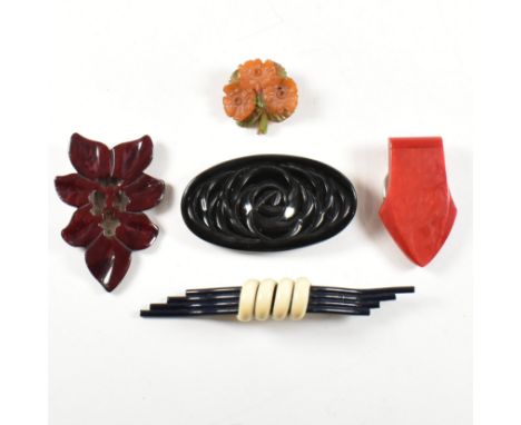 A collection of early plastic brooches clips and a belt buckle. The brooches to include carved Bakelite floral spray. Black B