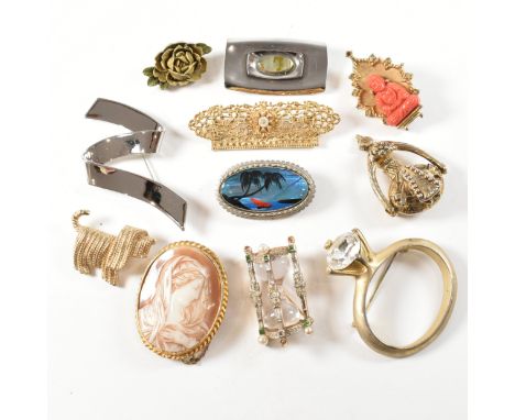 A collection of eleven vintage brooches. The lot to include a gem set Trifari brooch in the form of a sand timer. A Cordia ye